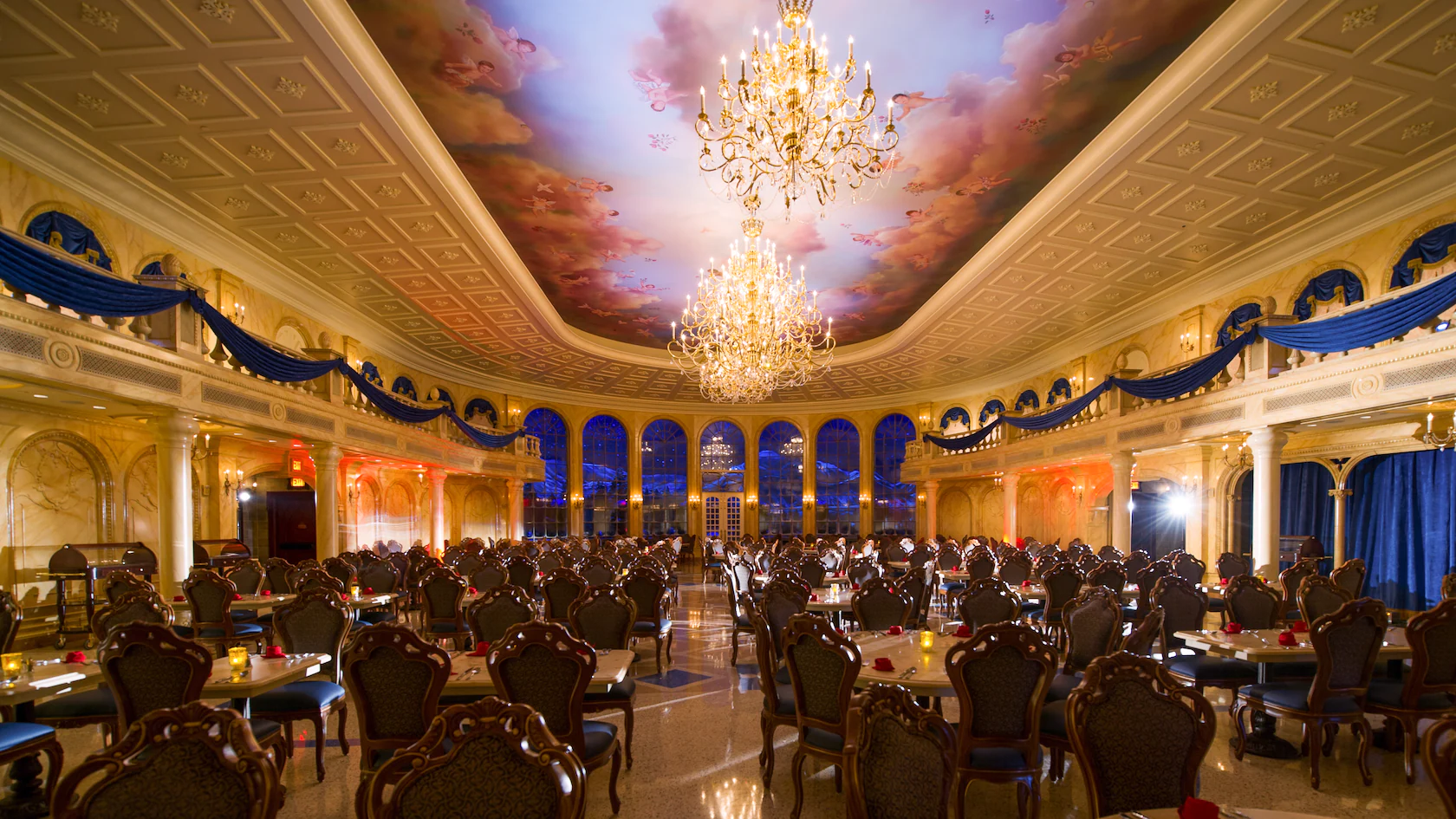 Internal picture of Be Our Guest Restaurant Disney World. Grand dining hall with tables and chairs.