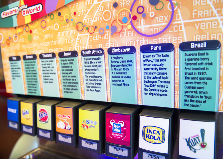 A picture of the international soda dispensers in a row at Club Cool. The countries feature Italy, Greece, Thailand, Japan, South Africa, Zimbabwe, Peru and Brazil.