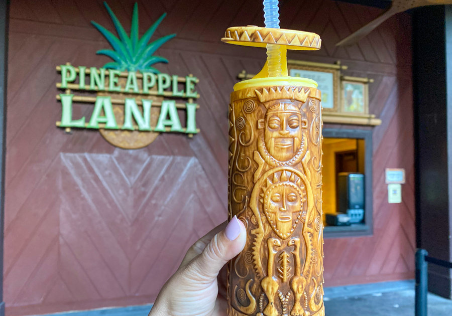 A picture of the Pineapple Dole Whip Float drink being held infront of Pineapple Lanai